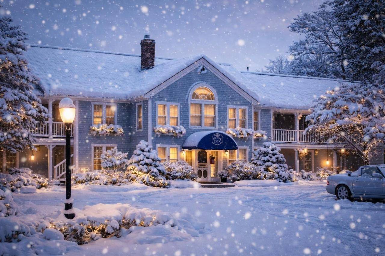 a house covered in snow with a car parked in the driveway at Cod Cove Inn, BW Signature Collection-Boothbay Harbor Area in Edgecomb
