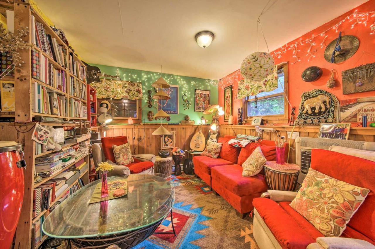 a living room with a red couch and a glass table at Magical Hideaway Offering a Unique Experience in Montsweag