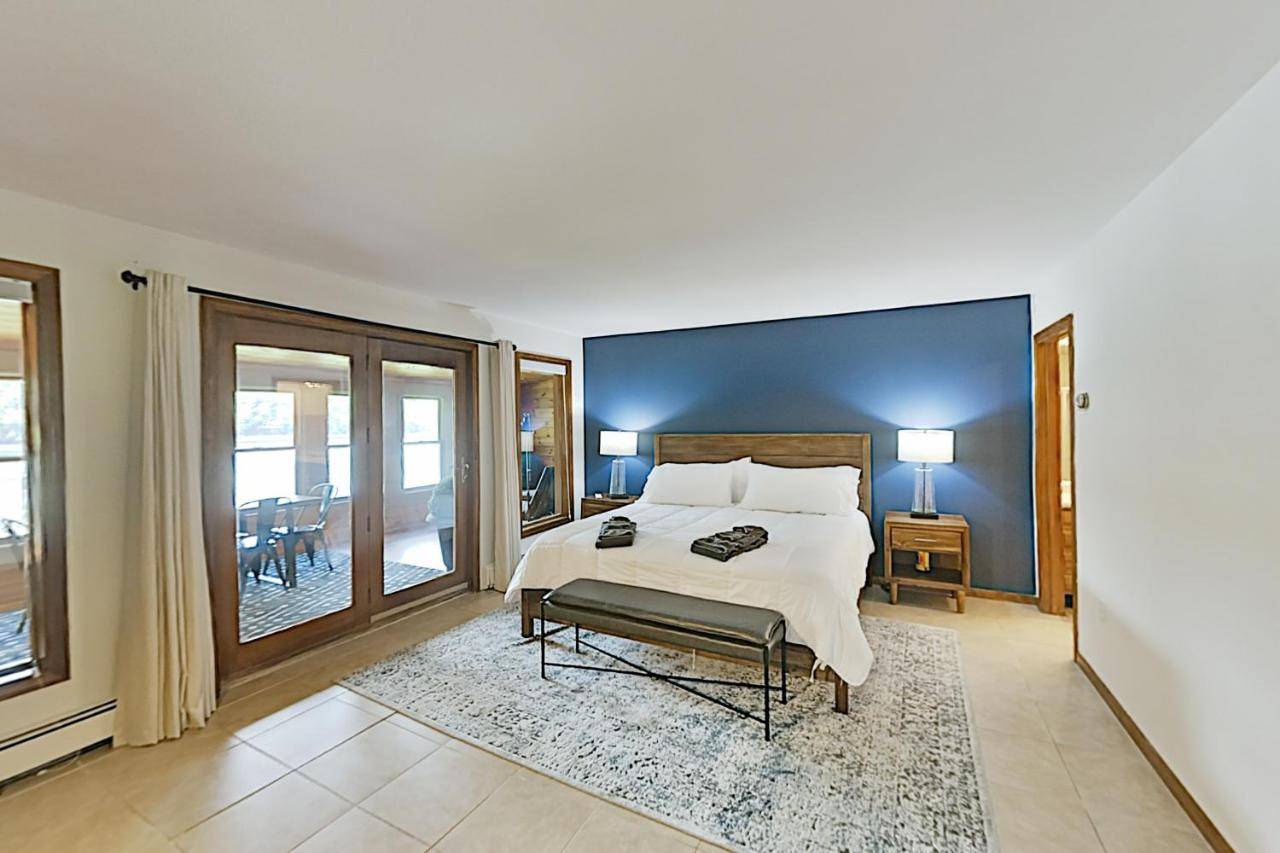 a bedroom with a large bed and a chair in it at Westport Waterfront in Montsweag