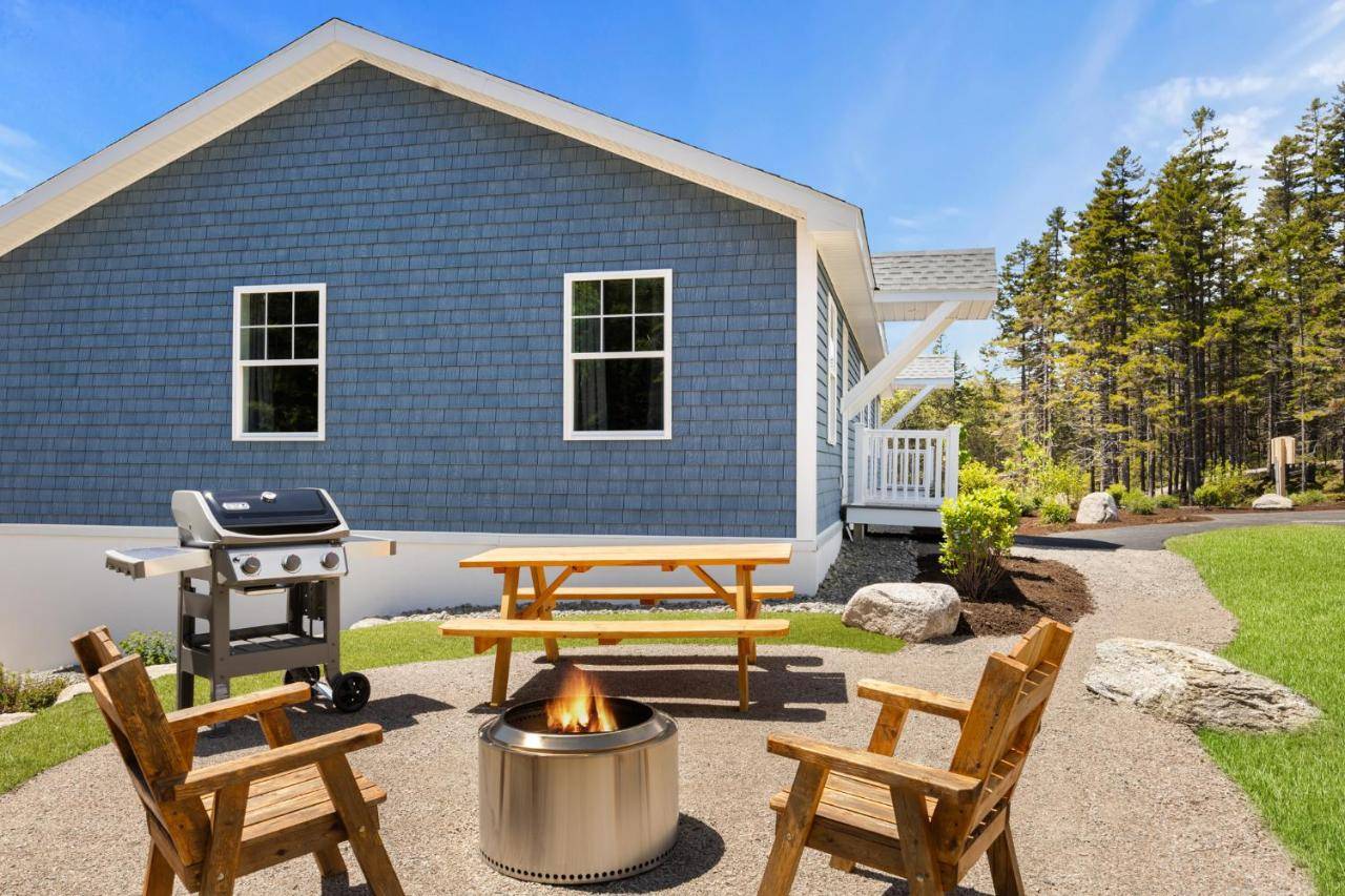a backyard with a picnic table and a grill at Apple Blossom Cottage - Cozy Romantic Escape in Bernard