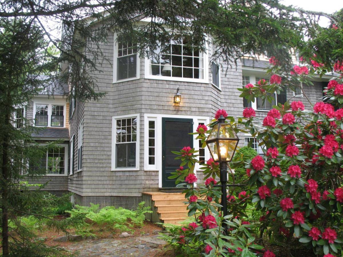 a house with pink flowers in front of it at Harbourside Inn in Northeast Harbor