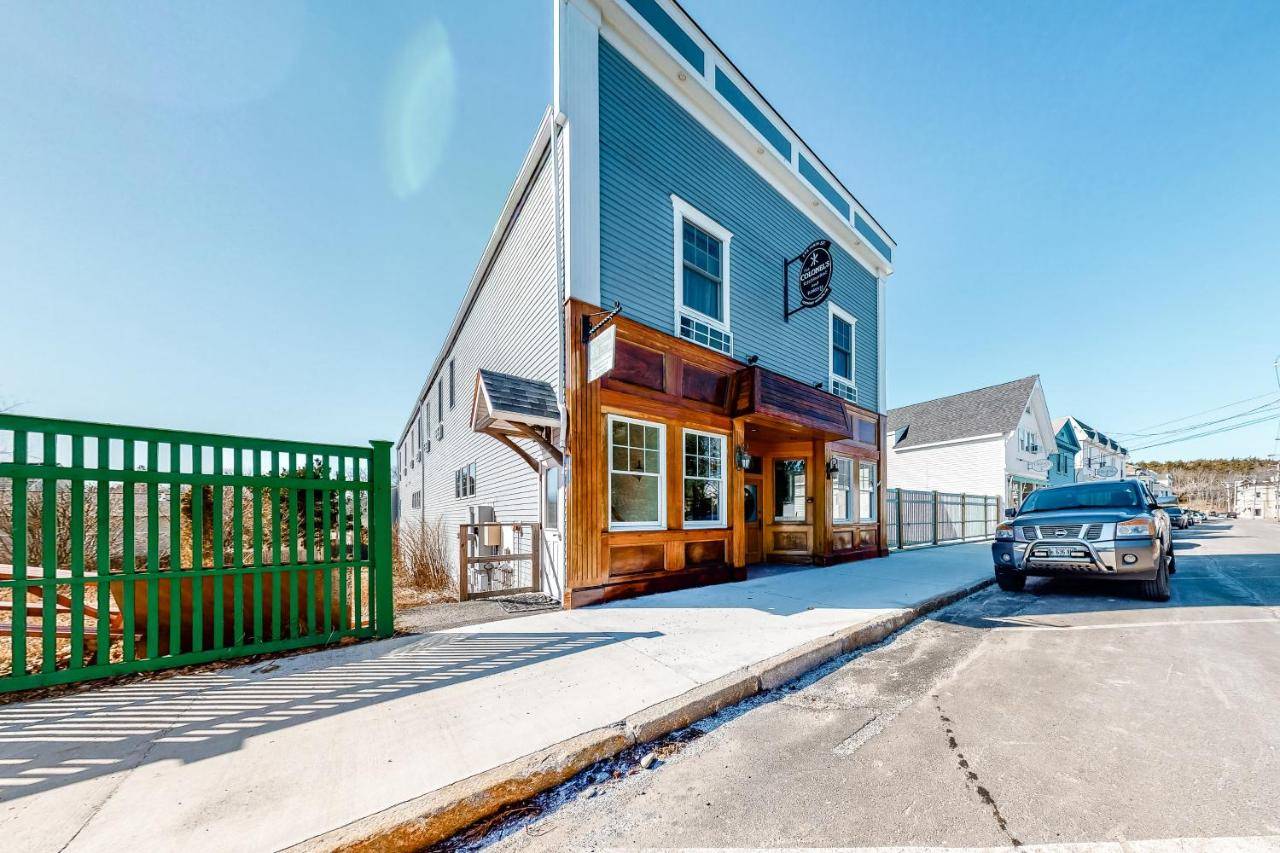 a car parked in front of a building on a street at The Colonels Suites Unit 2 in Northeast Harbor