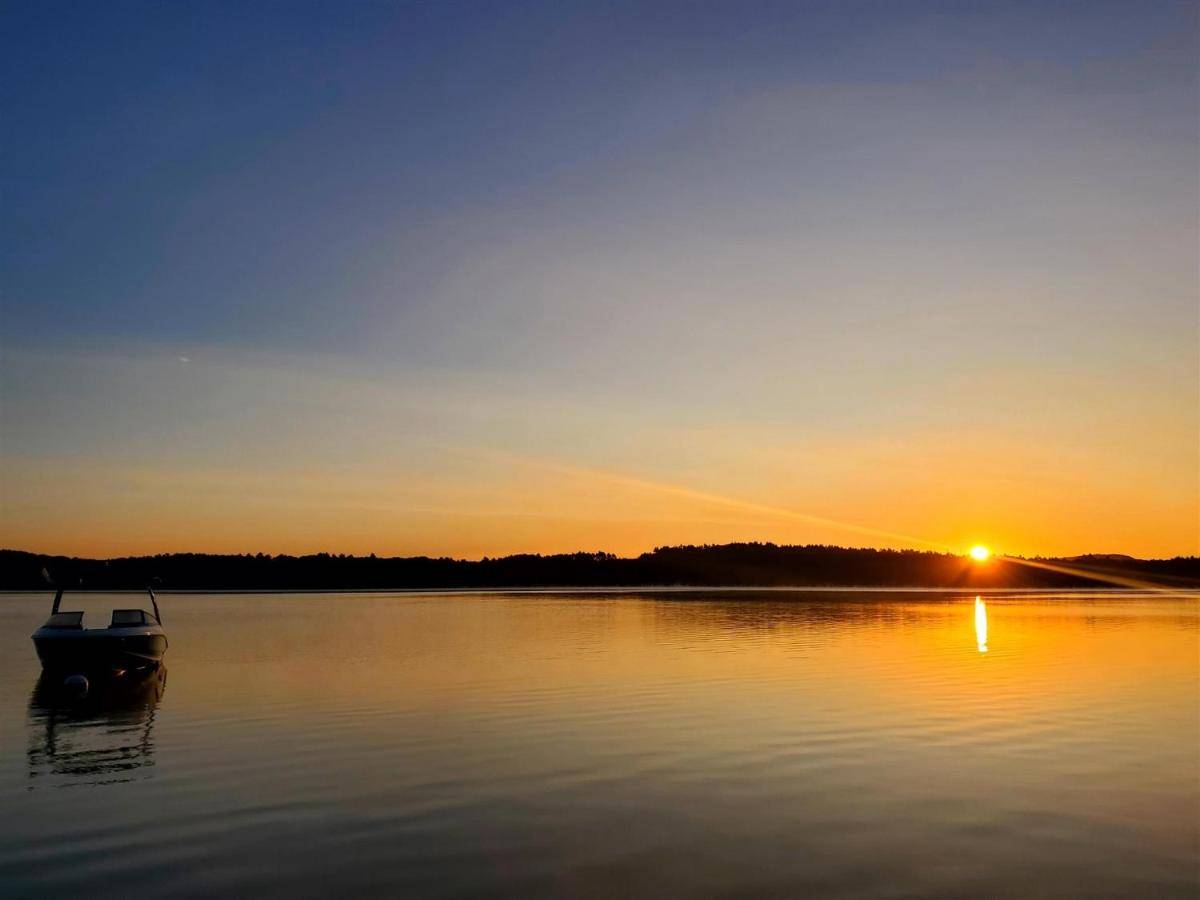 a boat on a lake at sunset at LOONS VIEW LIMIT 20 home in Naples