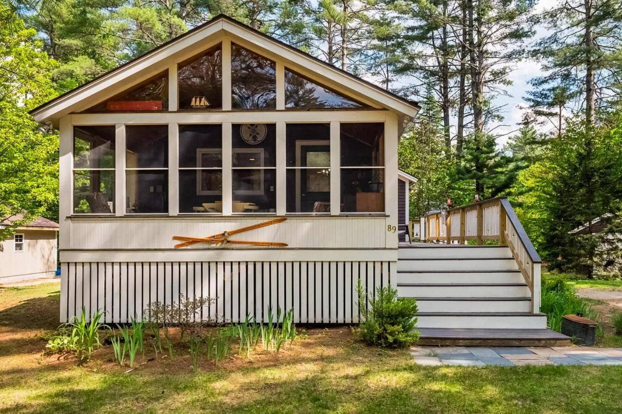 a tiny house with a large window and stairs at The Mountain Bungalow in Newry