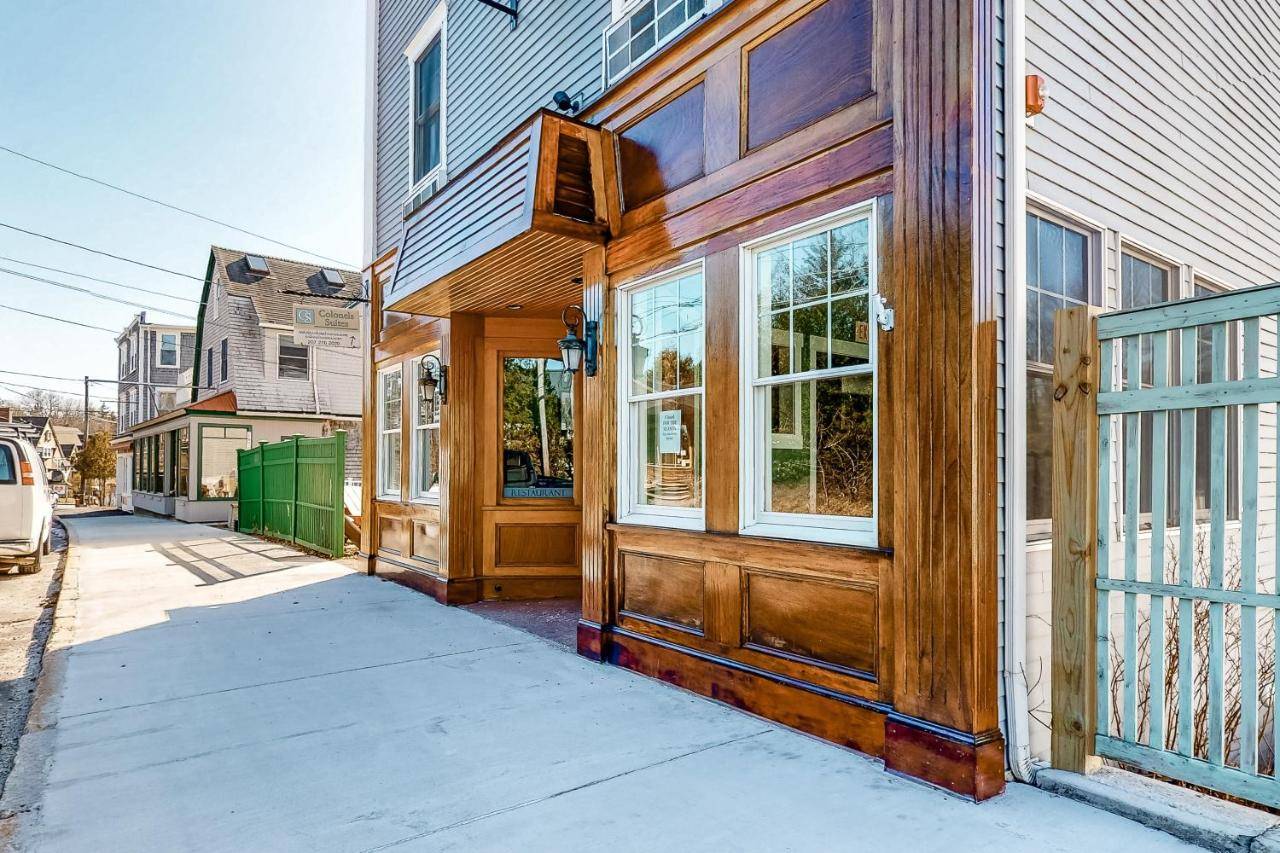a house with a wooden door on a street at The Colonels Suites #4 in Northeast Harbor