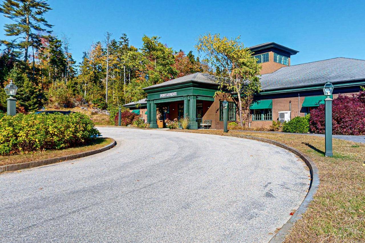 a house with a road in front of a building at Point Lookout in Northport