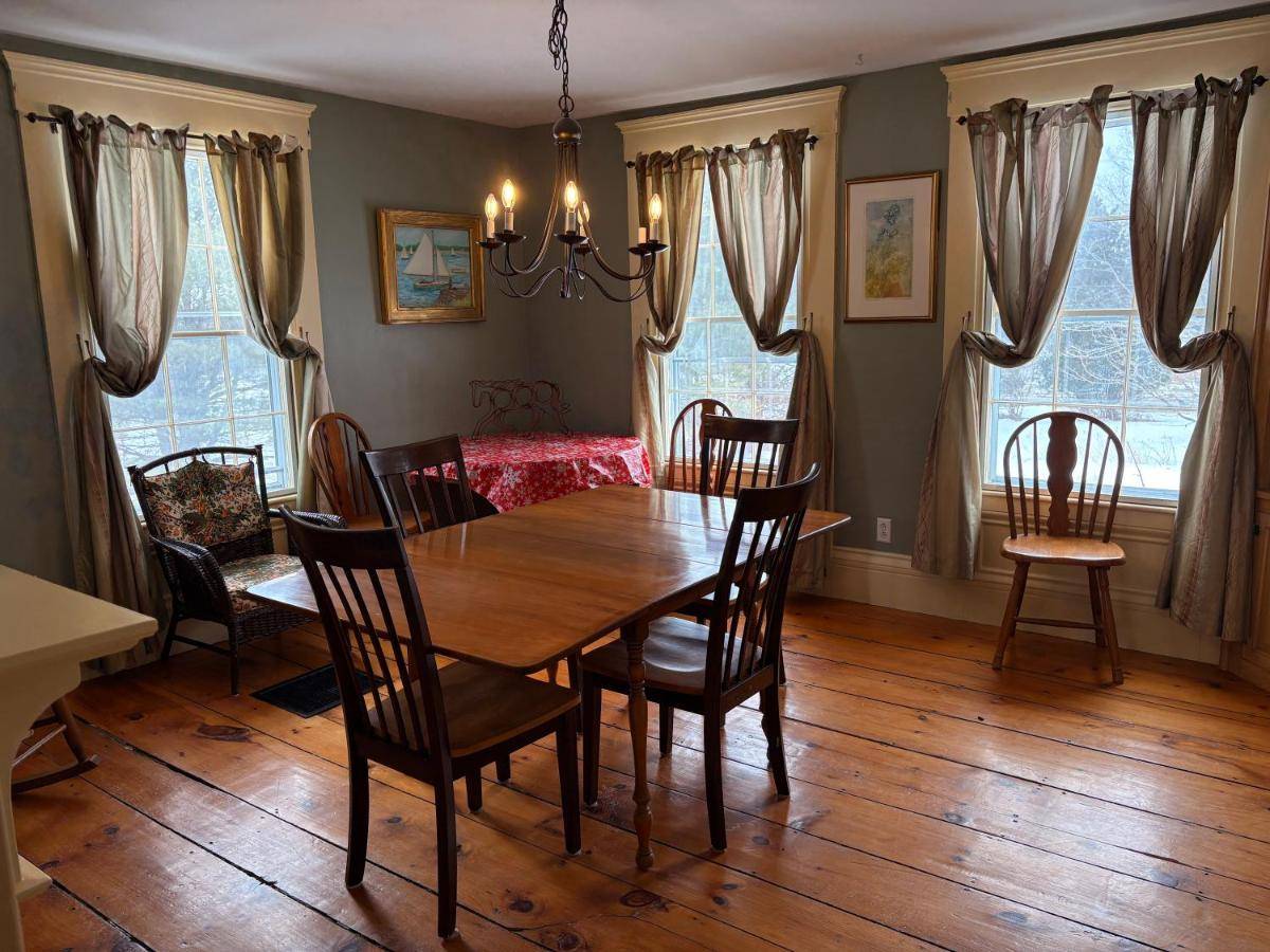 a dining room with a wooden table and chairs at My Valhalla Farm-Room Rentals in Oakland