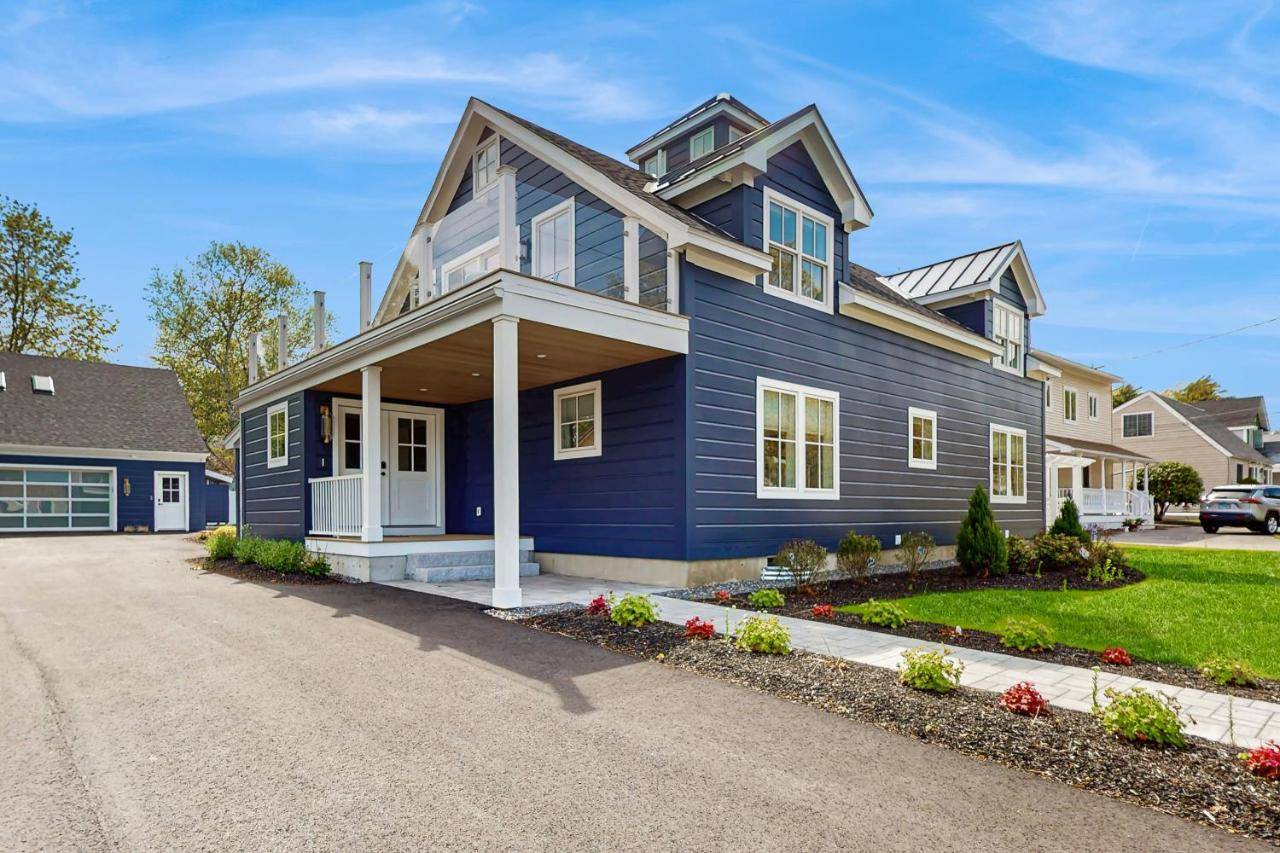 a blue house with a driveway at Barefoot Bliss in Ogunquit