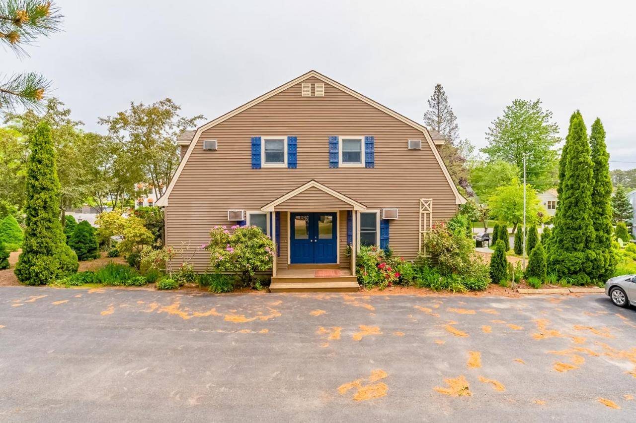 a house with a blue door on a driveway at Beach Plum Townhouse in Ogunquit
