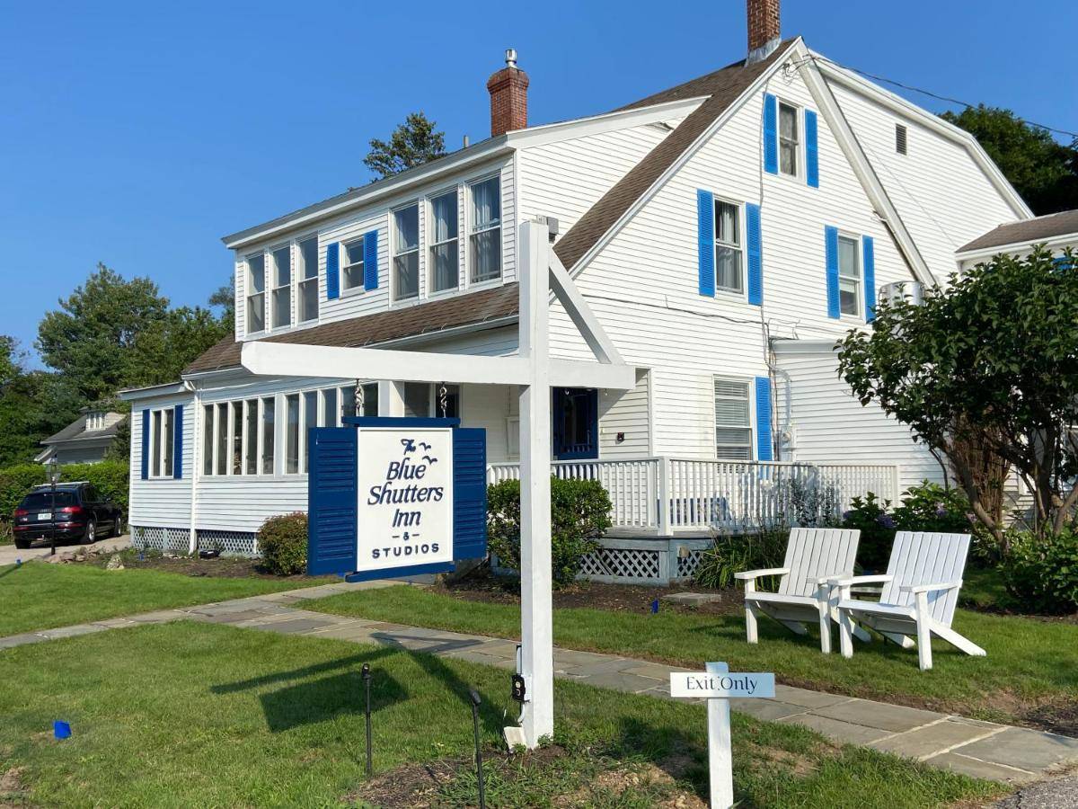 a white house with a sign in front of it at Blue Shutters Inn and Studios in Ogunquit