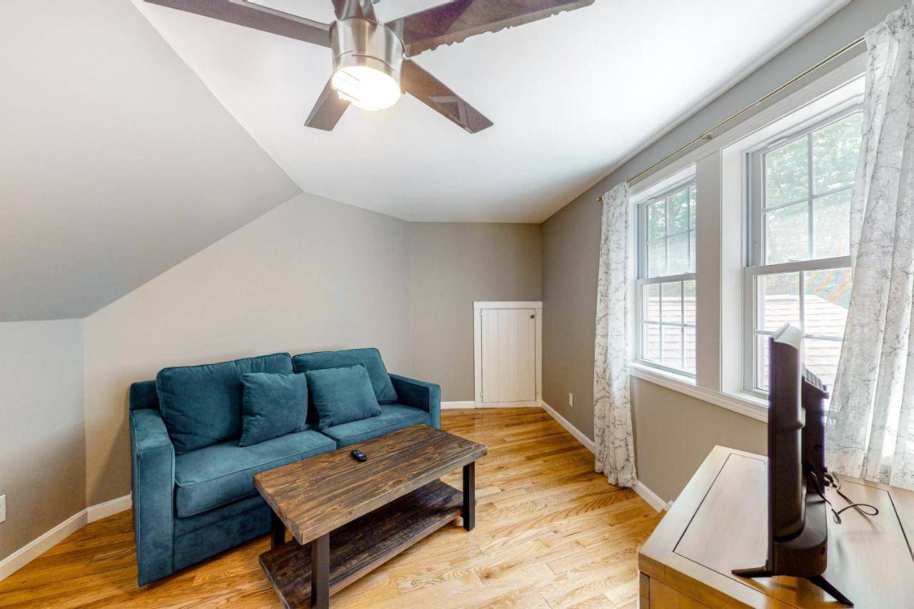 a living room with a blue couch and a table at Evergreen Terrace in Ogunquit