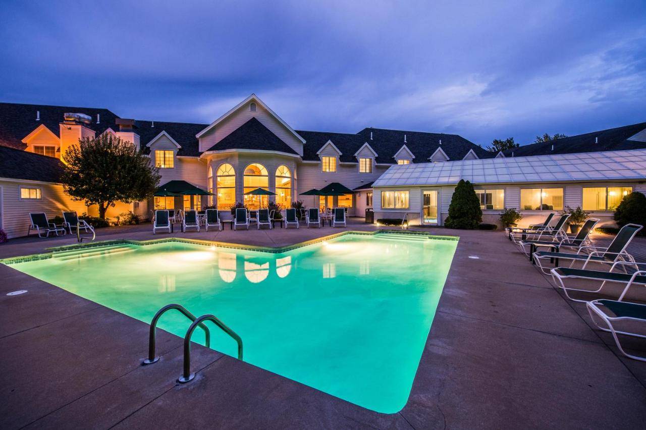 a large swimming pool in front of a house at Gorges Grant Hotel in Ogunquit