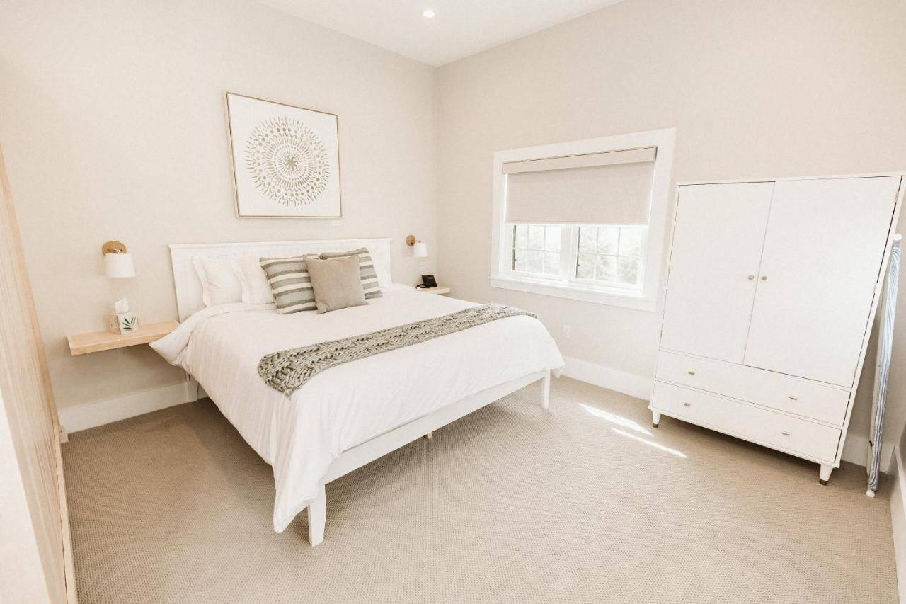 a white bedroom with a bed and a window at Grasshopper Inn in Ogunquit