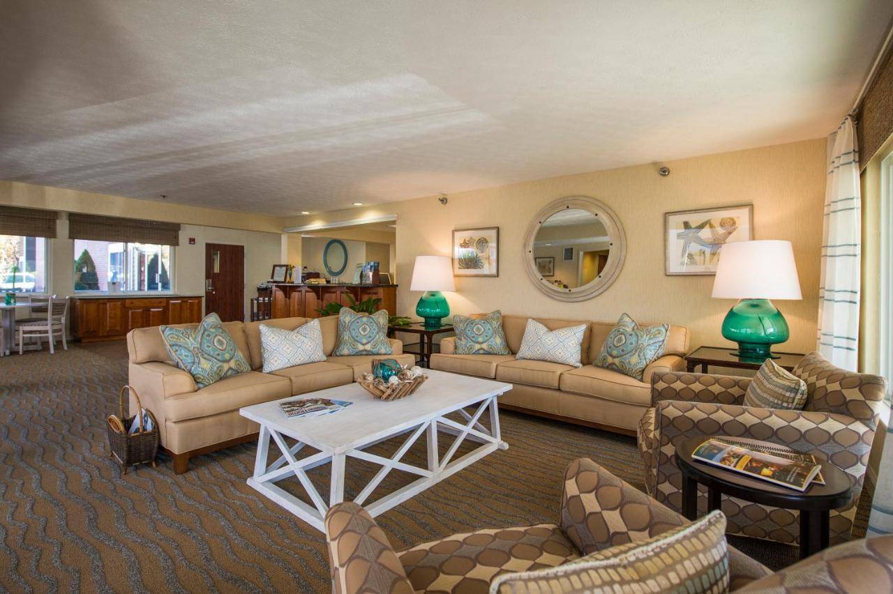 a living room with couches and a table at Juniper Hill Inn in Ogunquit