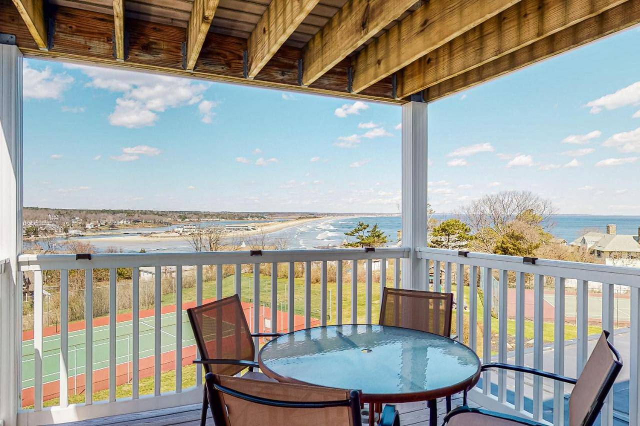 a balcony with a table and chairs and a view of the ocean at Ogunquit Beach Lookout in Ogunquit