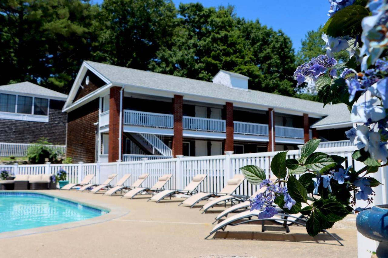 a resort with chairs and a swimming pool at Sea View Motel in Ogunquit