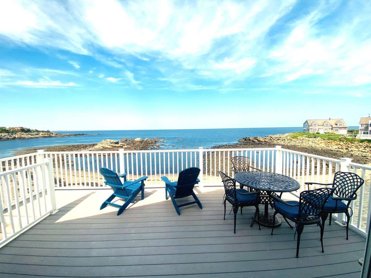 a deck with a table and chairs and the ocean at Seaside Serenity 2 Oceanfront in Ogunquit