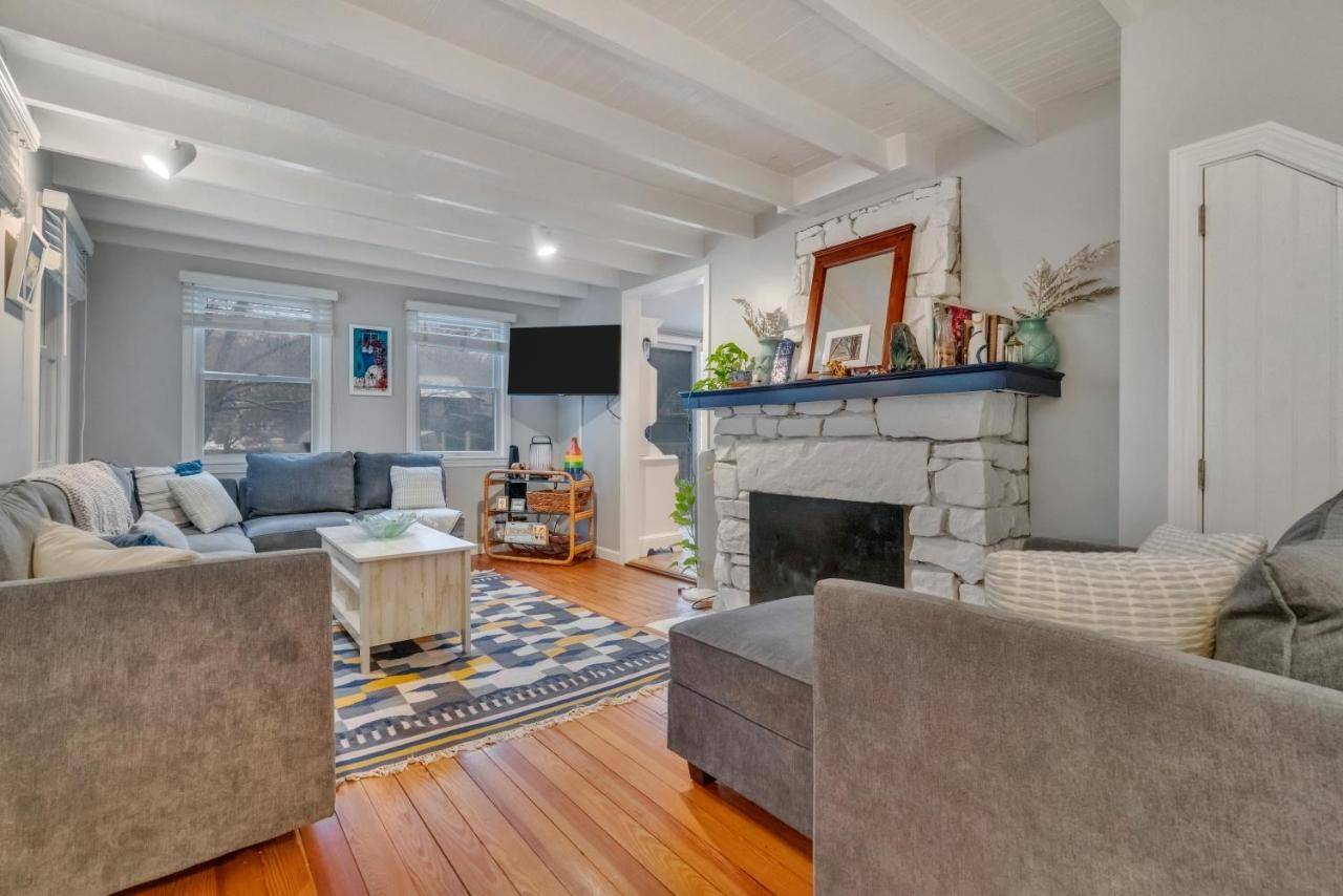 a living room with a couch and a fireplace at The District of Maine - Walk to downtown Ogunquit in Ogunquit