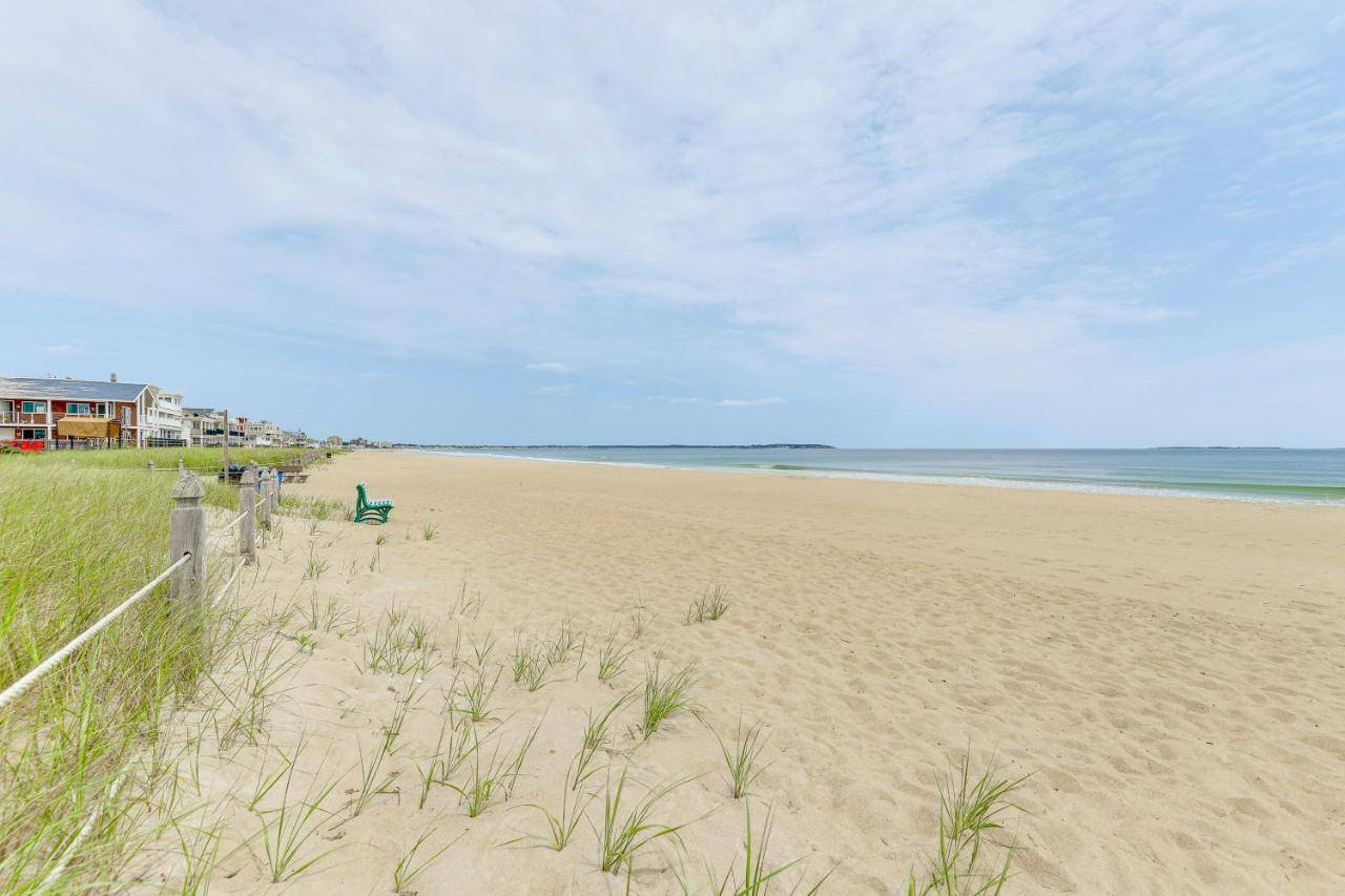 a sandy beach with a house and the ocean at 13 Mi to Portland Studio on Old Orchard Beach! in Old Orchard Beach