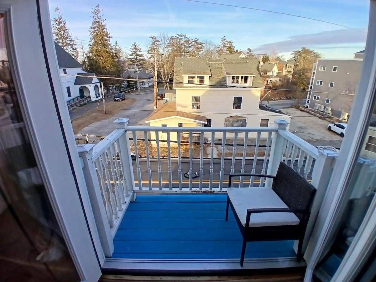 a balcony with a bench and a view at A balcony to the Ocean 7 min walk to the beach in Old Orchard Beach
