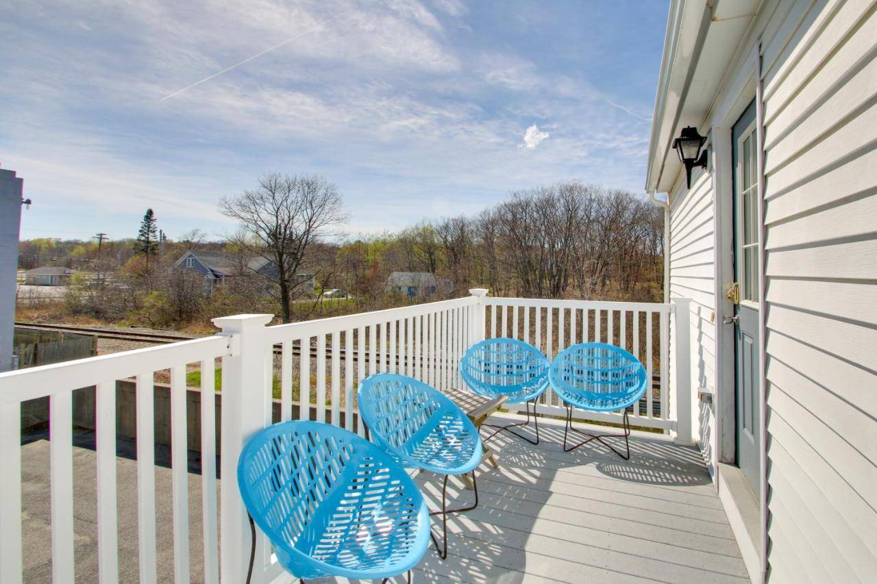 a porch with blue chairs and a white fence at Apt in Old Orchard Beach - Walk to Bay and Pier in Old Orchard Beach