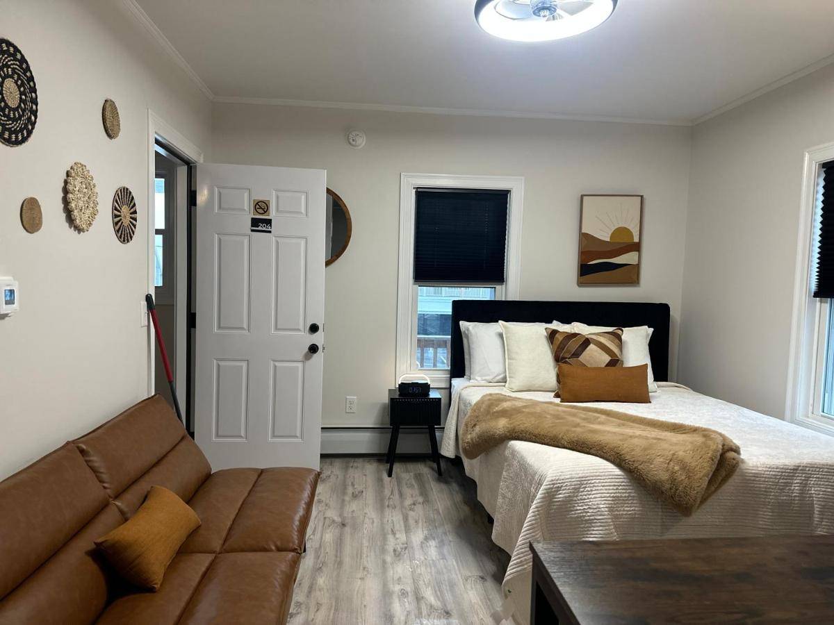 a bedroom with a bed and a couch at Aqua Amour Studio in Old Orchard Beach