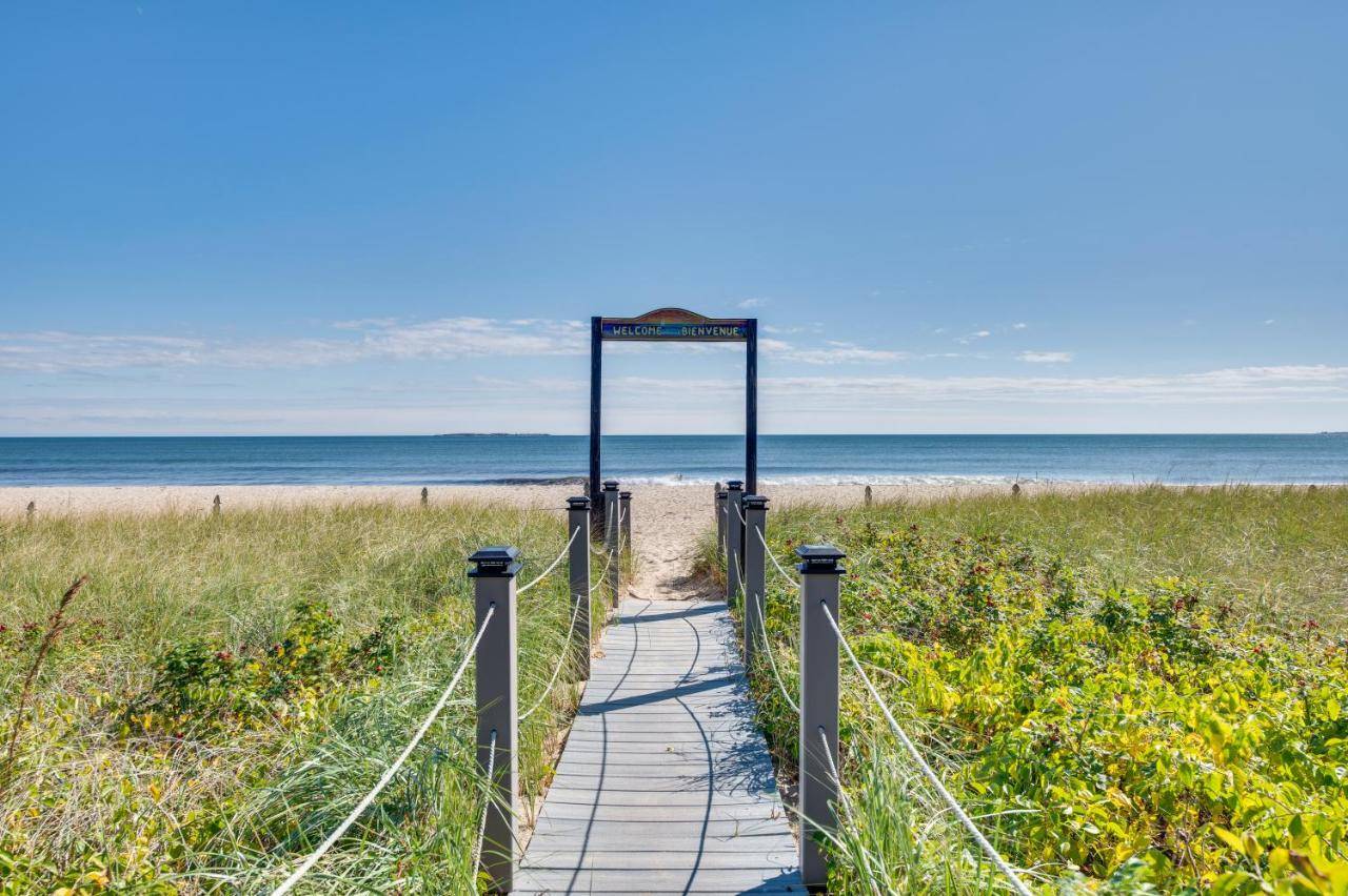 a wooden path to the beach with a sign on it at Beachfront 16 Condo on Old Orchard Beach in Old Orchard Beach