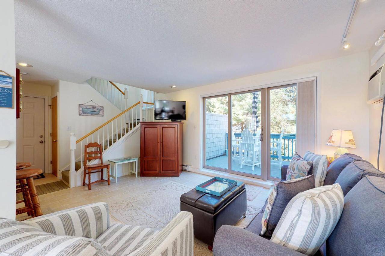 a living room with a couch and chairs and a tv at By the Sea in Old Orchard Beach