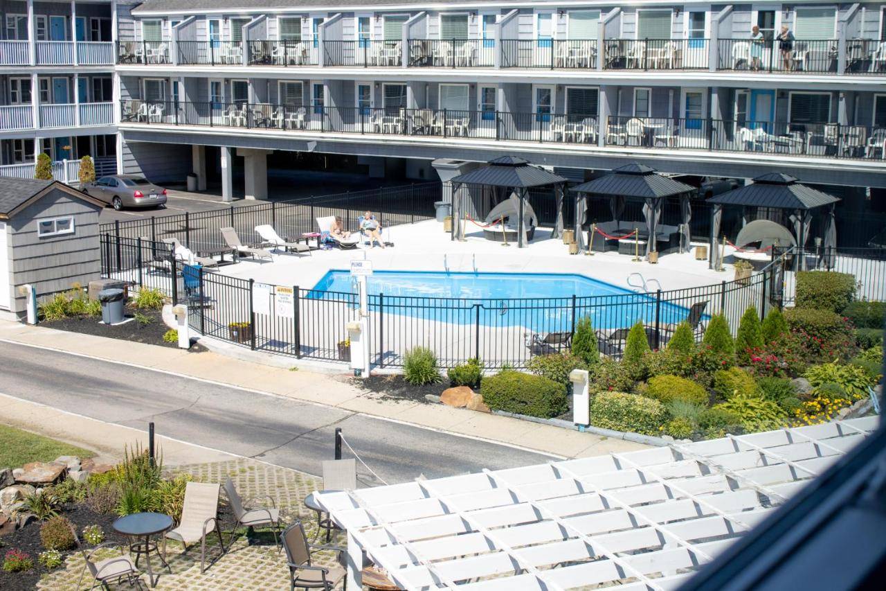 a swimming pool in front of a large building at The Grand Beach Inn in Old Orchard Beach