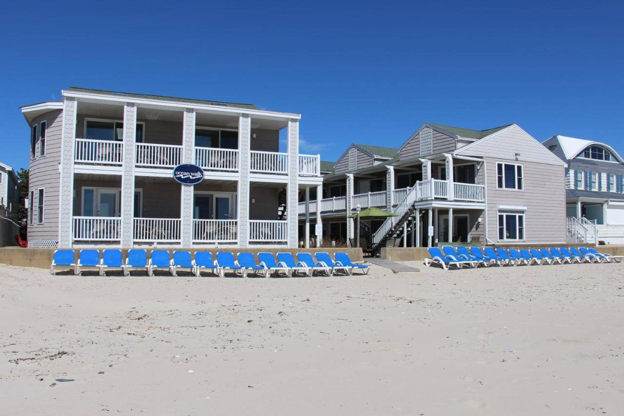 a group of blue beach chairs on the beach at Ocean Walk Hotel in Old Orchard Beach