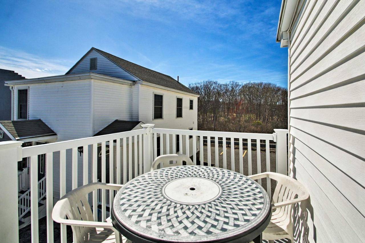 a table and chairs sitting on a balcony at Old Orchard Beach Apt - Walk to Beach and Pier! in Old Orchard Beach