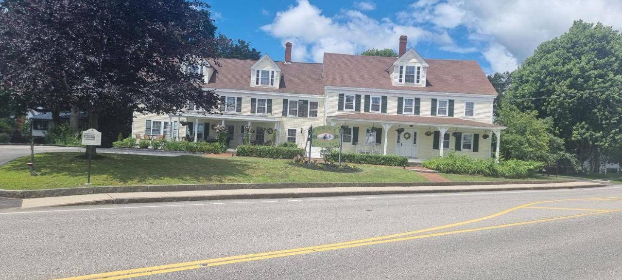 a large white house on the corner of a street at Old Orchard Beach Inn in Old Orchard Beach