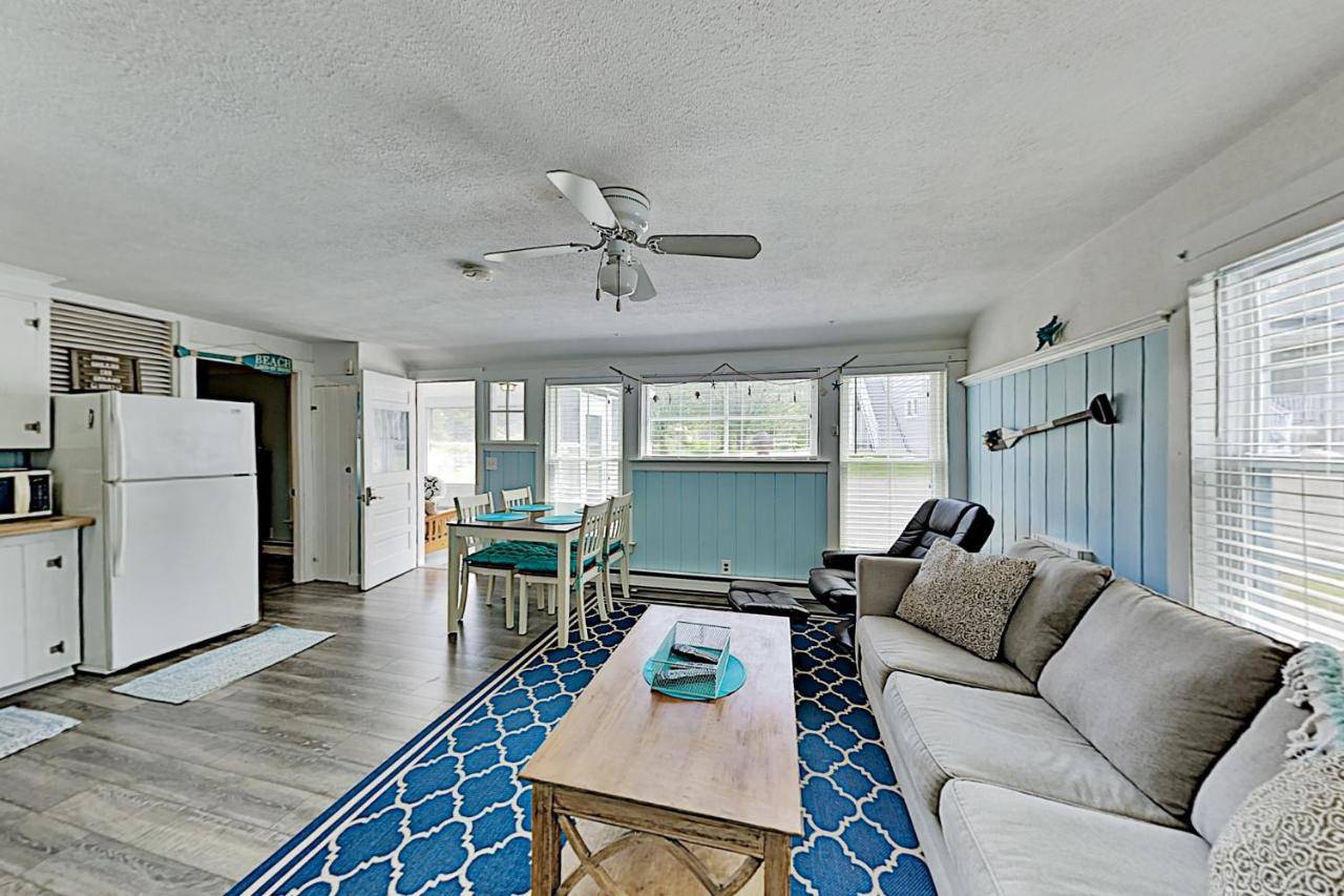 a living room with a couch and a table at Old Orchard Cottage in Old Orchard Beach