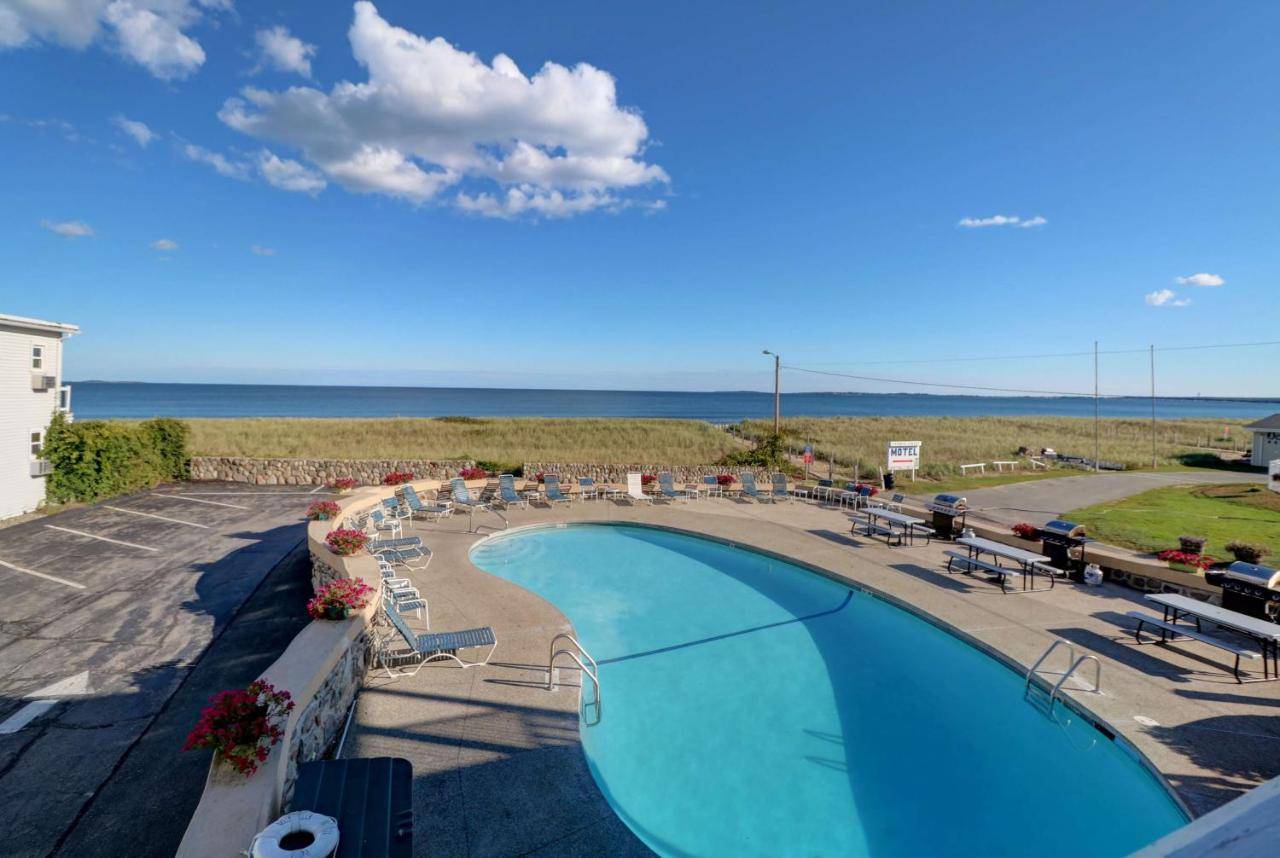 a view of a swimming pool and the ocean at Sea View Inn in Old Orchard Beach