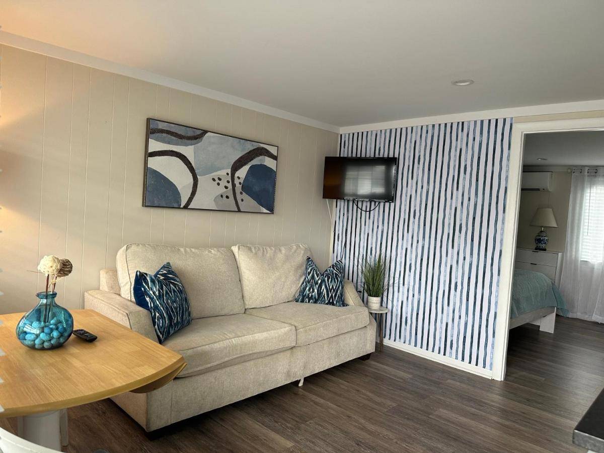 a living room with a couch and a table at Shoreline Suite in Old Orchard Beach