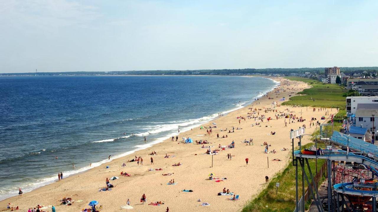 a group of people on a beach near the water at Sky Deck 302 in Old Orchard Beach