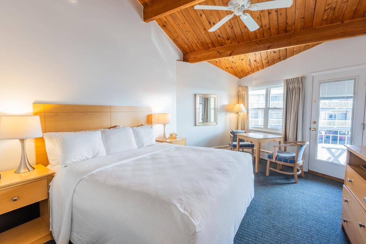 a bedroom with a large white bed and a desk at The Gull Oceanside Inn & Motel in Old Orchard Beach