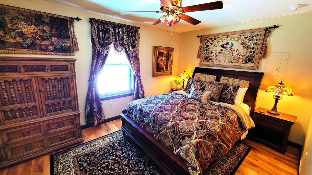 a bedroom with a bed and a ceiling fan at The Sovereign Suite - Cozy And Convenient With Home Theater in Old Town