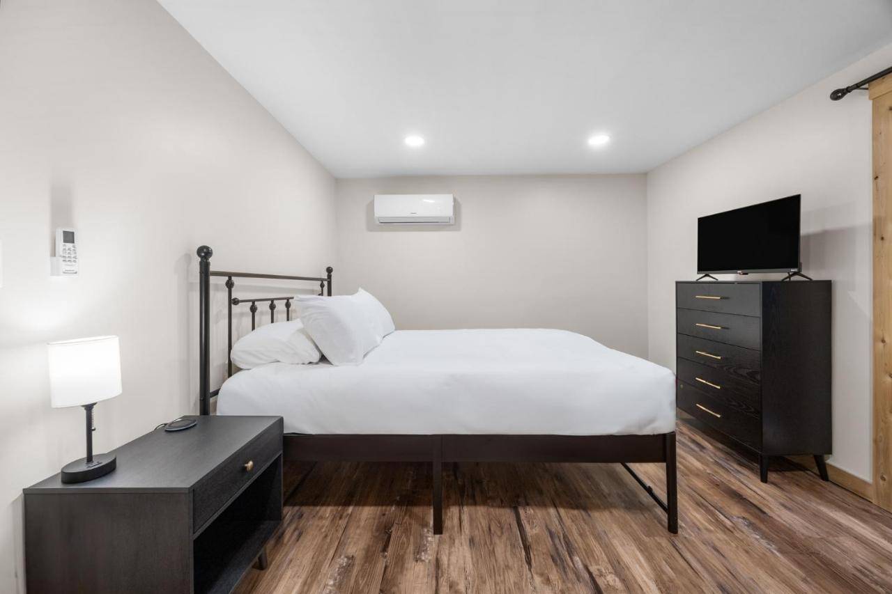 a bedroom with a bed and a dresser with a television at Cozy Home in Pittsfield in Pittsfield