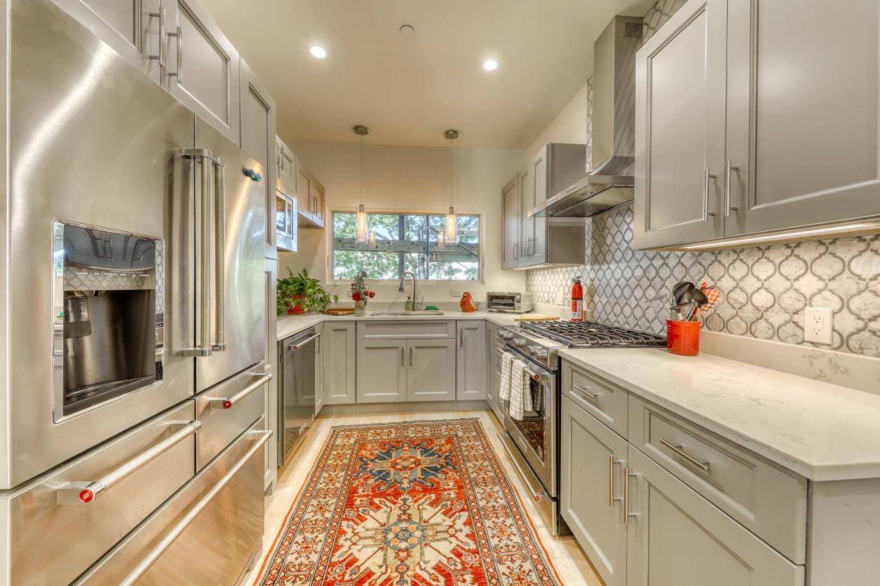 a kitchen with white cabinets and a rug on the floor at A Foodie s Delight in Portland