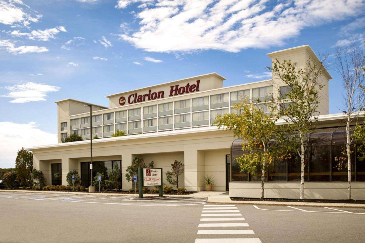 a building with a sign that reads garden hotel at Clarion Hotel Portland Airport ME in Portland
