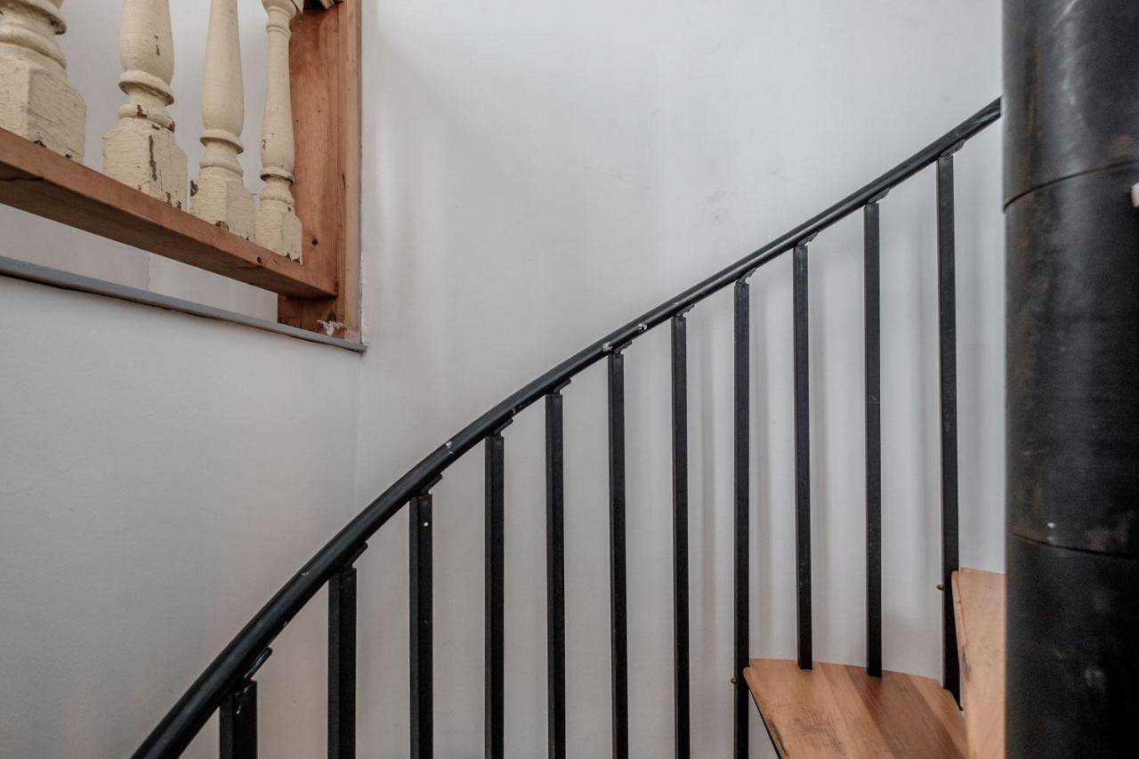 a staircase in a building with a mirror on the wall at Crow's Nest in Portland