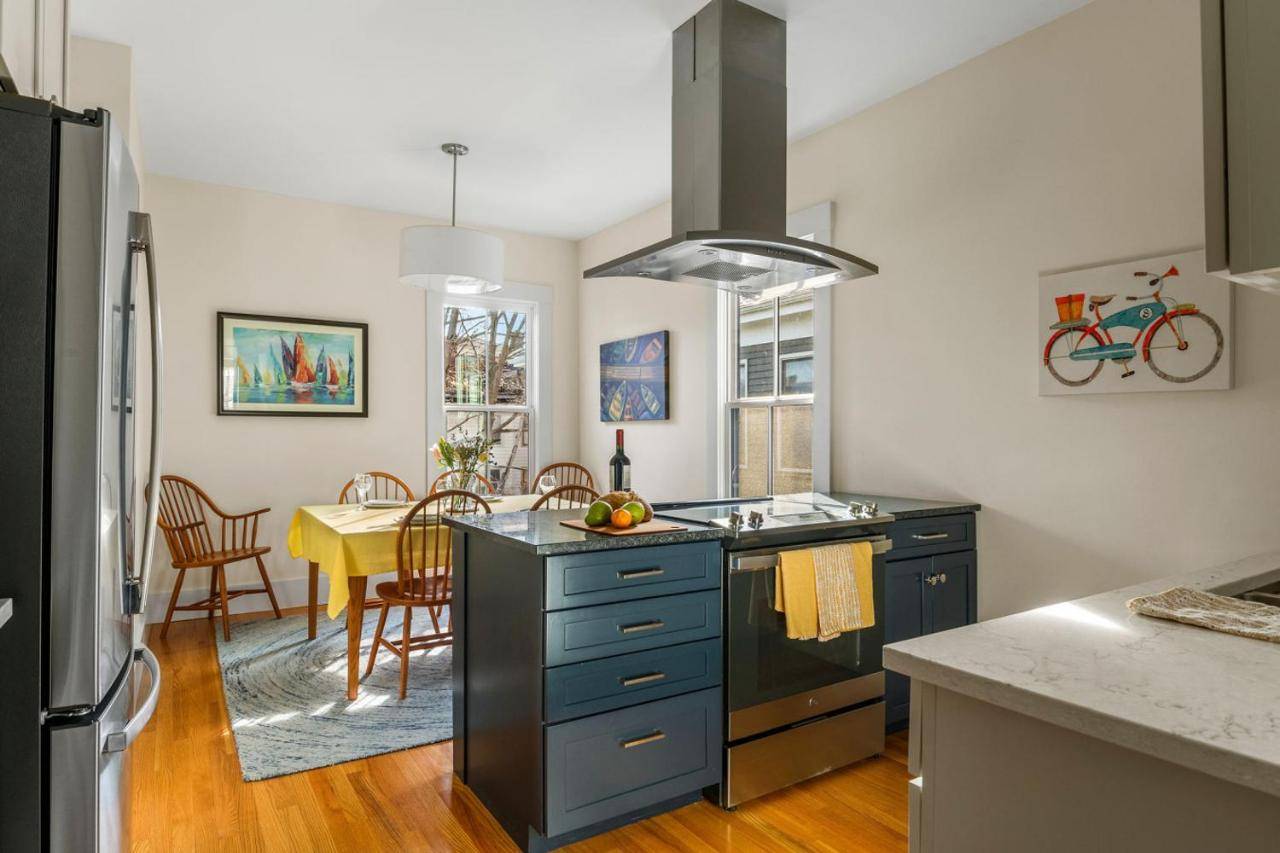 a kitchen with a sink and a stove at Luxurious West End Historic Townhome - The Cushman in Portland