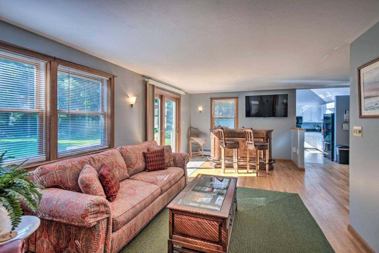 a living room with a couch and a table at Charming Saco Home with Deck, 5 Mi to Beach! in Saco