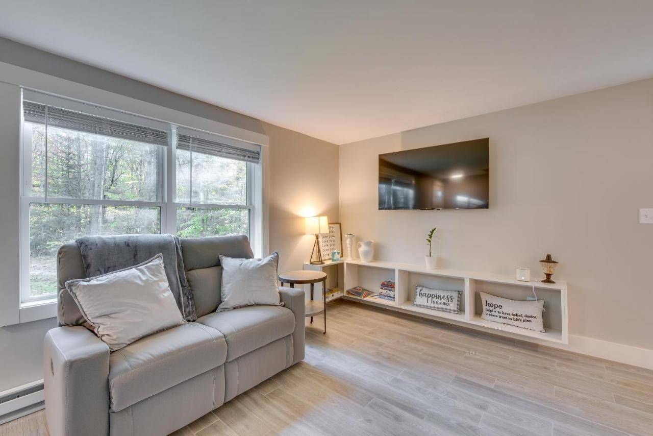 a living room with a couch and a window at Maine Escape with Grill, Near Skiing and Hiking! in Saco