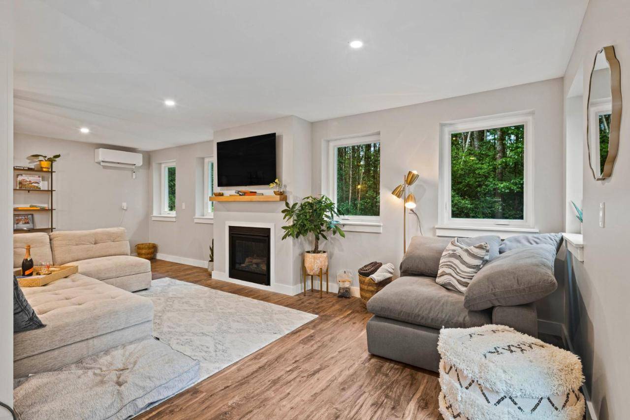 a living room with a couch and a fireplace at Modern Gem on 15 Acres, 5 Mi to Old Orchard Beach! in Saco