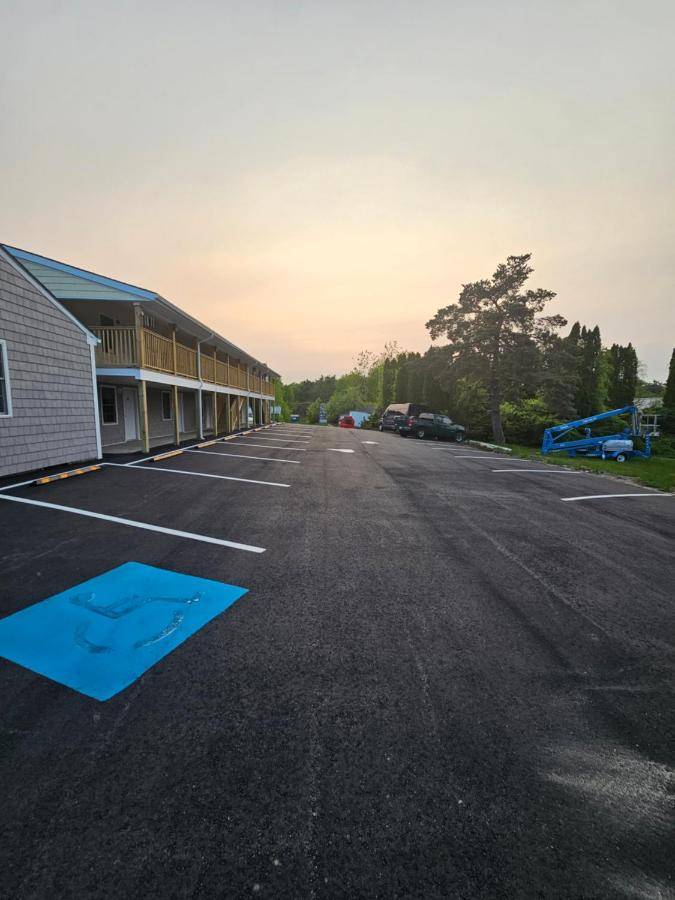 an empty parking lot in front of a building at Vacation Inn in Saco