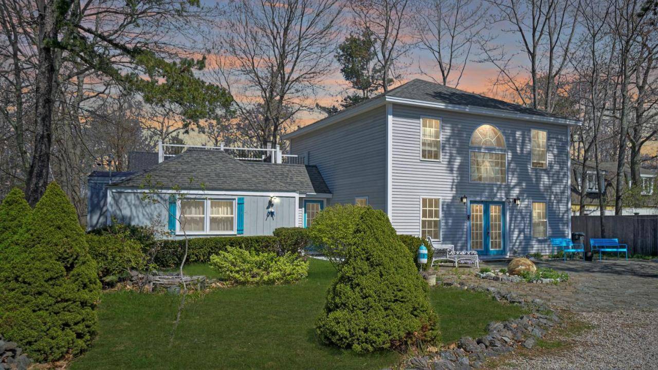 a blue and white house with a yard at Blue Doors By The Sea by Bayley Vacation Rentals in Scarborough