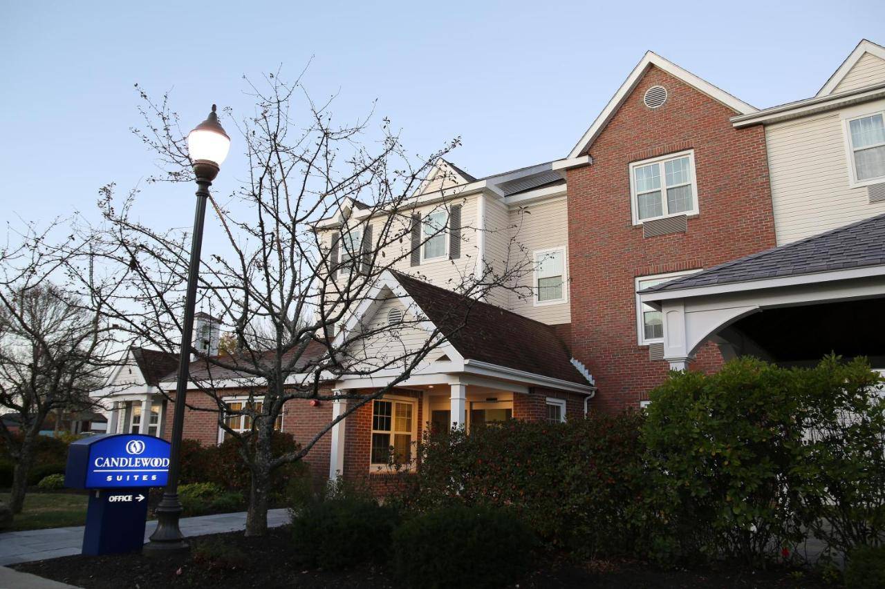a house with a sign in front of a street light at Candlewood Suites - Portland - Scarborough by IHG in Scarborough