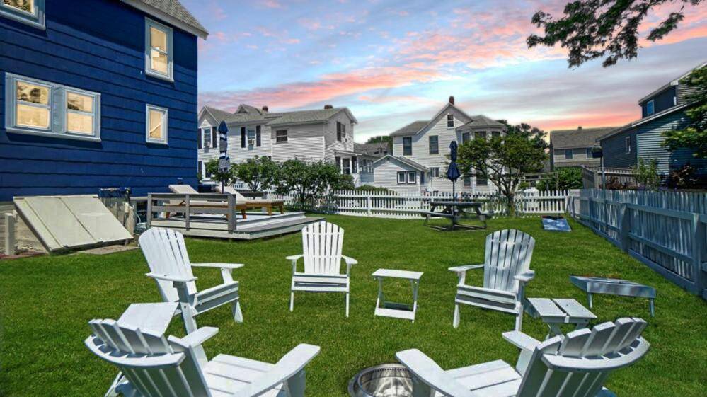 a group of chairs and tables in a yard at Driftwood Cottage by Bayley Vacation Rentals in Scarborough